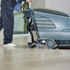 Cleaner pre-sweeping with a floor scrubber dryer